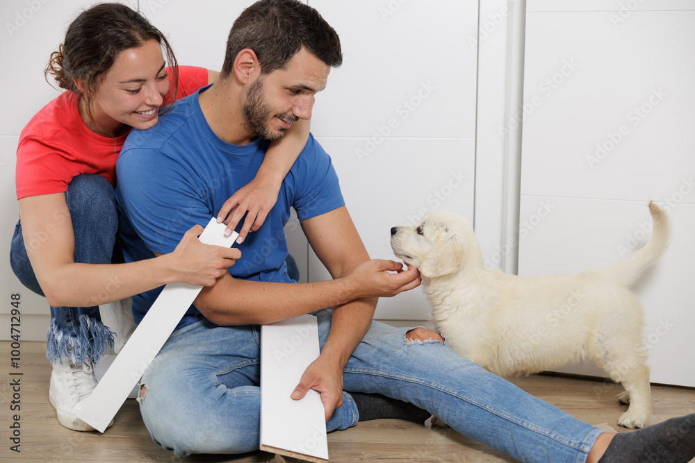 Portrait of a young couple with their golden retriever puppy. Family moments. Sharing time with loved ones. No to animal abandonment. Pets. The dog is man's best friend. Portrait of a young couple with their golden retriever puppy. Family moments. Sharing time with loved ones. No to animal abandonment. Pets. The dog is man's best friend.