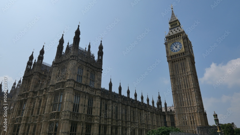 Sunny summer day in London, capturing the iconic Big Ben with clear skies. Showcasing the historic landmark's intricate architecture and its prominent place in the city's skyline. Sunny summer day in London, capturing the iconic Big Ben with clear skies. Showcasing the historic landmark's intricate architecture and its prominent place in the city's skyline.
