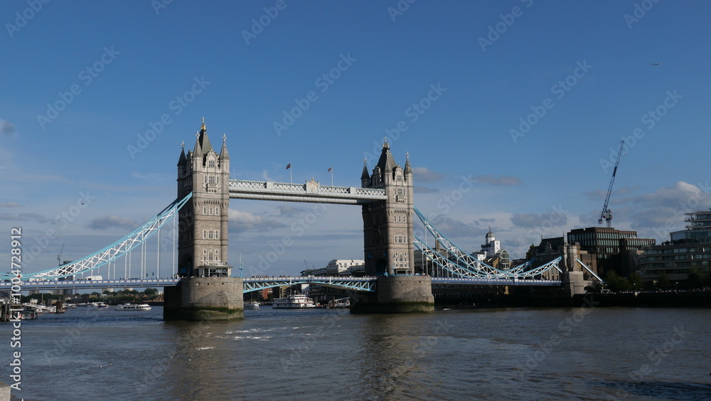 Fototapeta premium View of Tower Bridge in London, spanning the River Thames. Showcasing the iconic bridge's stunning Gothic architecture and its prominent role in the city's skyline.