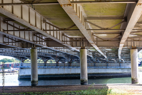 Motorway bridge in the UK, Image shows a bridge supporting the M27 over a river as traffic passes by on top on a cold Autumn day photo