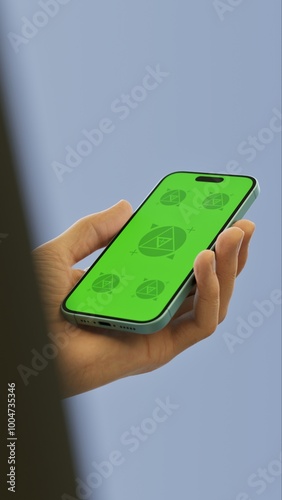 Wallpaper Mural Caucasian White middle aged male using smartphone with a blank green screen. Mobile app mockup. Vertical phone orientation Torontodigital.ca