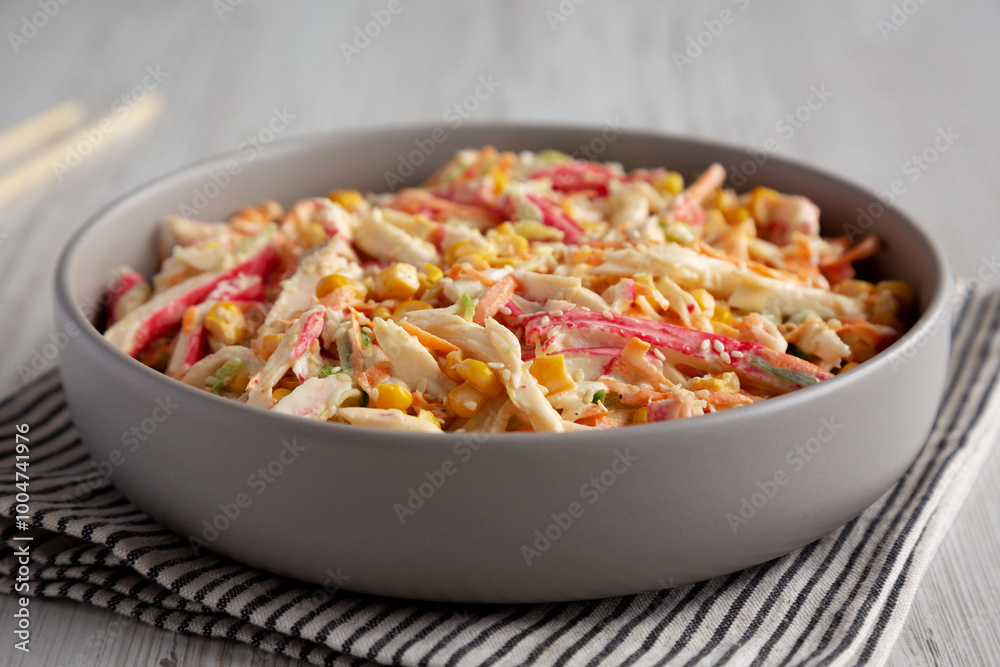 Homemade Japanese Kani Salad with Crab Sticks and Vegetables on a Plate, side view. Homemade Japanese Kani Salad with Crab Sticks and Vegetables on a Plate, side view.