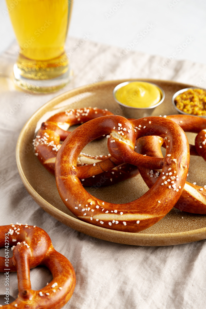 Homemade Bavarian-Style Soft Pretzels with Salt and Beer, side view. Homemade Bavarian-Style Soft Pretzels with Salt and Beer, side view.