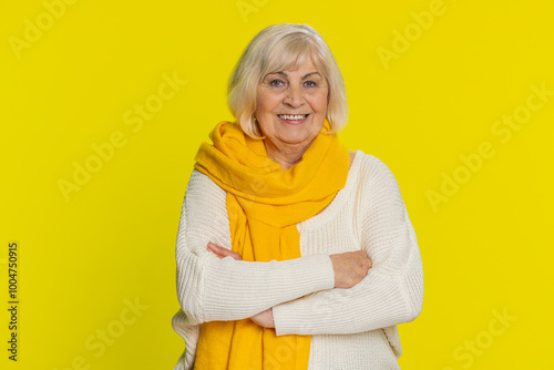 Portrait of happy senior old woman smiling friendly, glad expression looking at camera dreaming, resting relaxation feel satisfied good news. Elderly grandmother pensioner on yellow background indoors