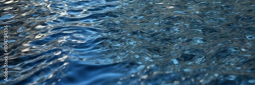 Photograph of deep blue water with ripples and light reflections, perfect for nature backgrounds or aquatic-themed designs.