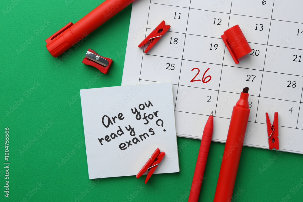 Paper note with question Are You Ready For Exam and stationery on green background, flat lay Paper note with question Are You Ready For Exam and stationery on green background, flat lay