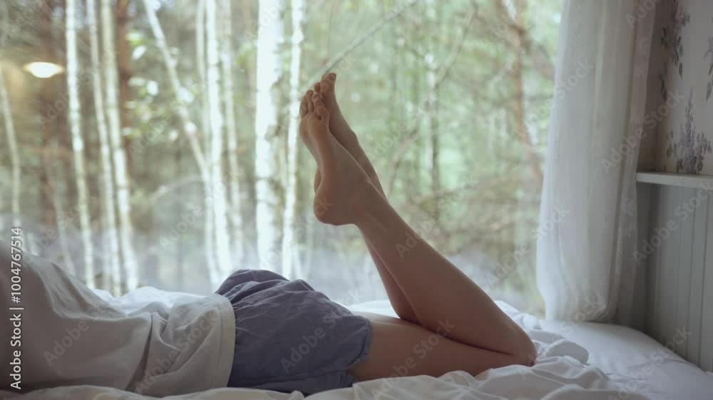 Close up of young woman tan skinned legs and feet playing 