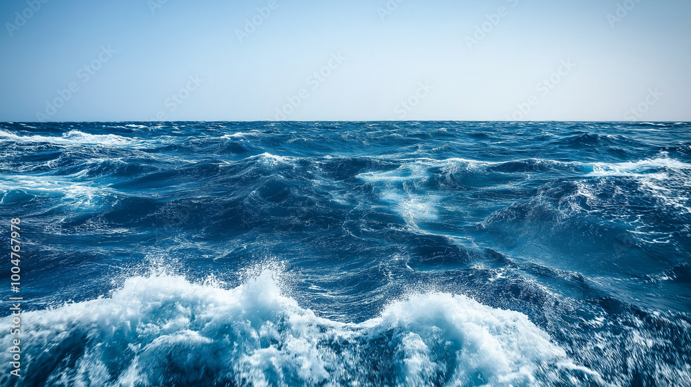 Ocean waves with intense blue tones and white foam crashing against the surface, capturing the dynamic and powerful energy of the sea, ideal for maritime themes and nature-inspired designs.