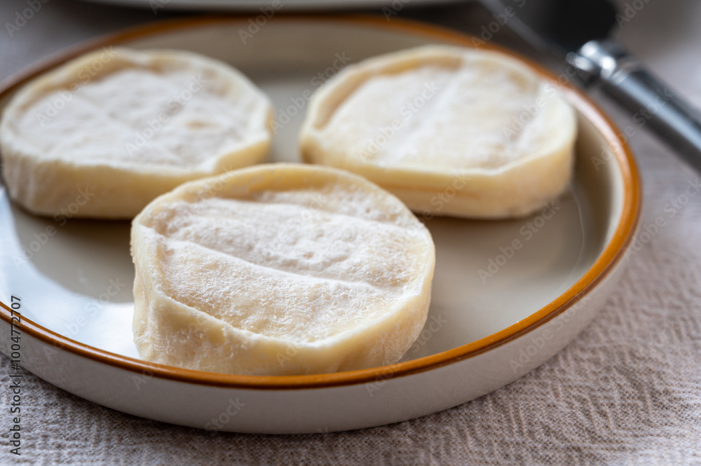 Rocamadour or cabecous soft goat AOC cheese with soft rind produced on farm in Perigord and Quercy on farmers market, departement Lot, France Rocamadour or cabecous soft goat AOC cheese with soft rind produced on farm in Perigord and Quercy on farmers market, departement Lot, France