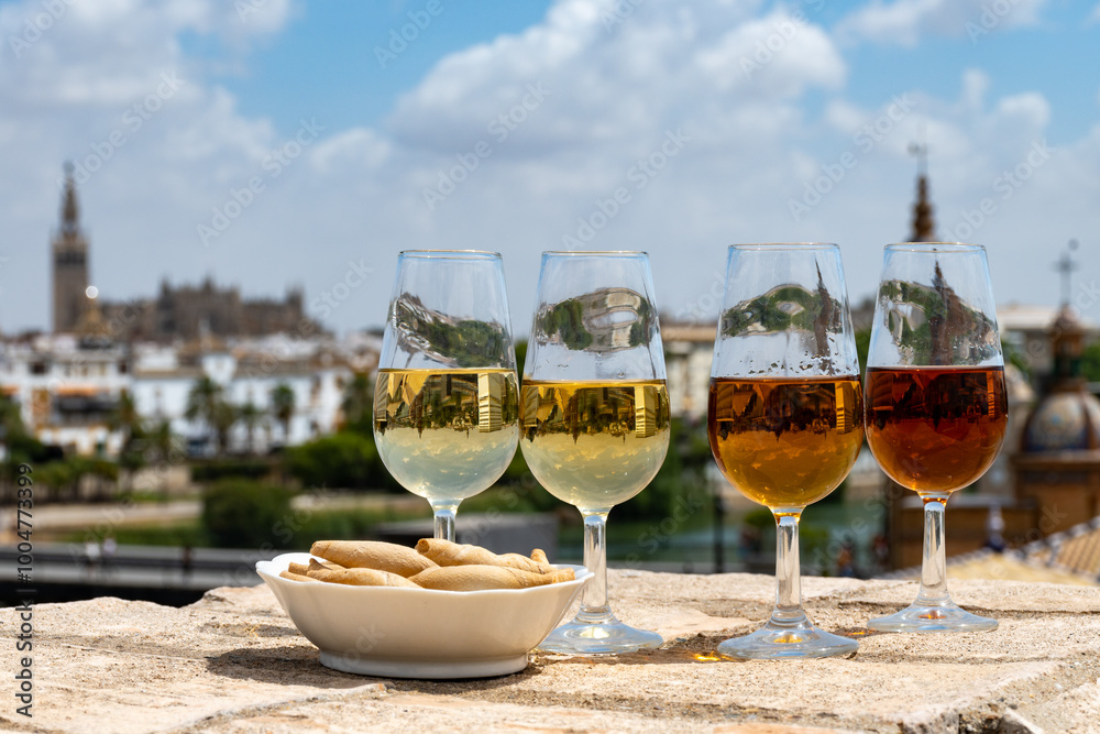 Fototapeta premium Sherry wine tasting on roof of old Triana district in Sevilla with view on Sevilla houses and churches, wine glasses