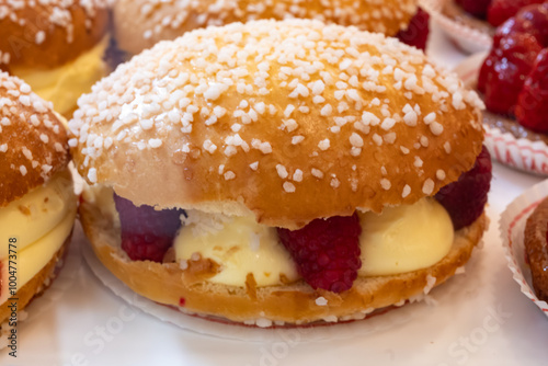 Cake Tarte tropezienne or La Tarte de Saint-Tropez - dessert pastry consisting of filled brioche with cream and fresh red berries