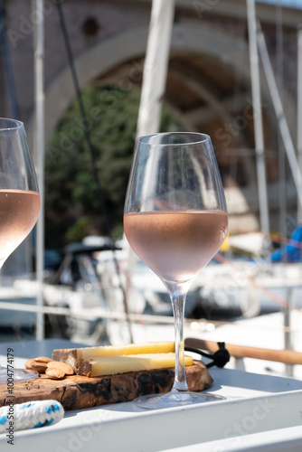 Party with rose wine on yacht boat anchored in port la Rague, Gulf of La Napoule, in Provence, two glasses of cold rose wine, French Riviera near Cannes, south of France photo