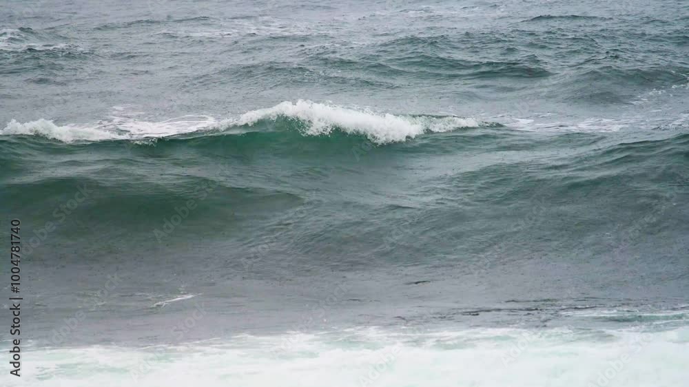Waves crashing on a beach in rain Waves crashing on a beach in rain