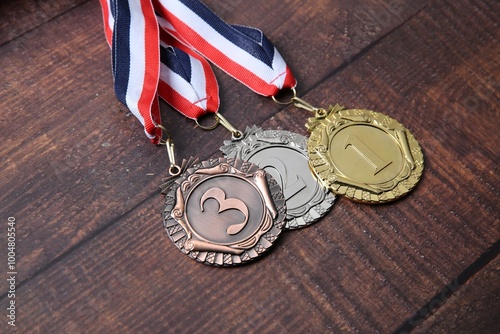 Golden, silver and bronze medals on wooden background, closeup photo
