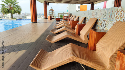 Brown lounge chairs or sun loungers made from rattan which are usually used in pools, swimming pools or spas.