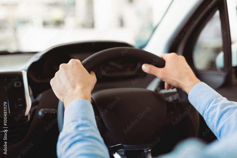 Driving A Car. Close Up Of Male Hands Holding Steering Wheel Inside Business Automobile Driving A Car. Close Up Of Male Hands Holding Steering Wheel Inside Business Automobile