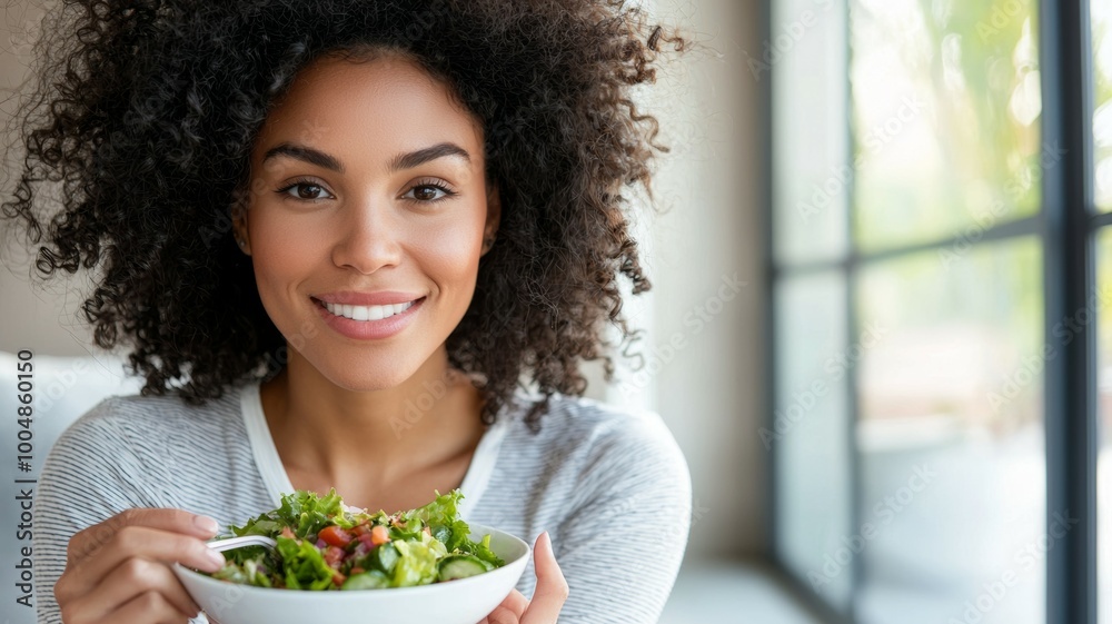 A woman is holding a salad bowl and smiling A woman is holding a salad bowl and smiling