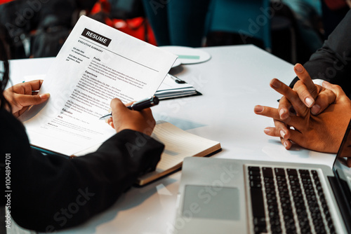 Fotografie Human resources department manager reads CV resume document of an employee candidate at interview room