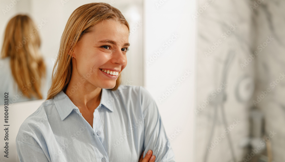 A youthful and vibrant woman poses with confidence in her stylishly designed bathroom, exuding joy and positivity A youthful and vibrant woman poses with confidence in her stylishly designed bathroom, exuding joy and positivity