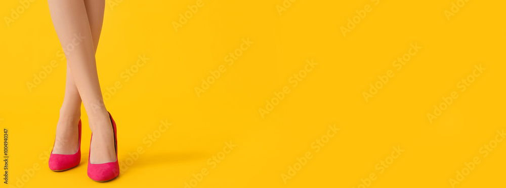 Legs of beautiful young woman in stylish high heels on yellow background Legs of beautiful young woman in stylish high heels on yellow background