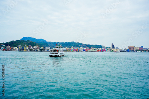 Kaohsiung, Taiwan, Republic of China, 01 25 2024: The landscape of Kaosiung port harbor, downtown,  seen on ferry boat from shiziwan (siziwan, xiziwan), and shoushan mountain to Cijin island photo