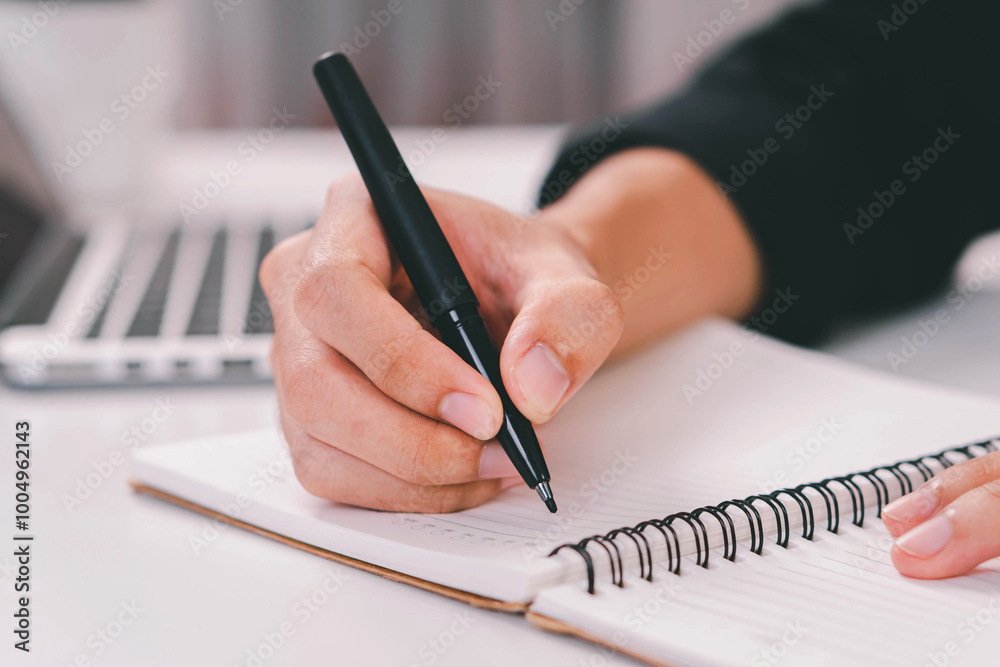 Male hand taking notes on the notepad. businessman working at work table, checklist writing planning investigate enthusiastic concept. focus on man hand holding pen, putting signature at official pape