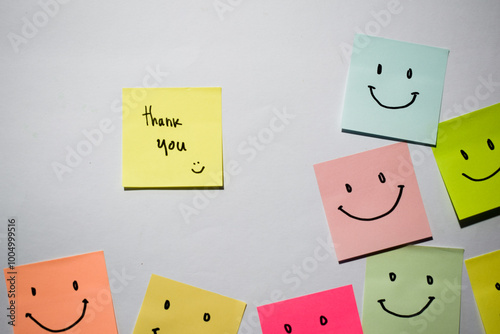 Thank you and smile emoticon on sticky notes. Motivational for personal development, inspirational handwriting. Isolated background