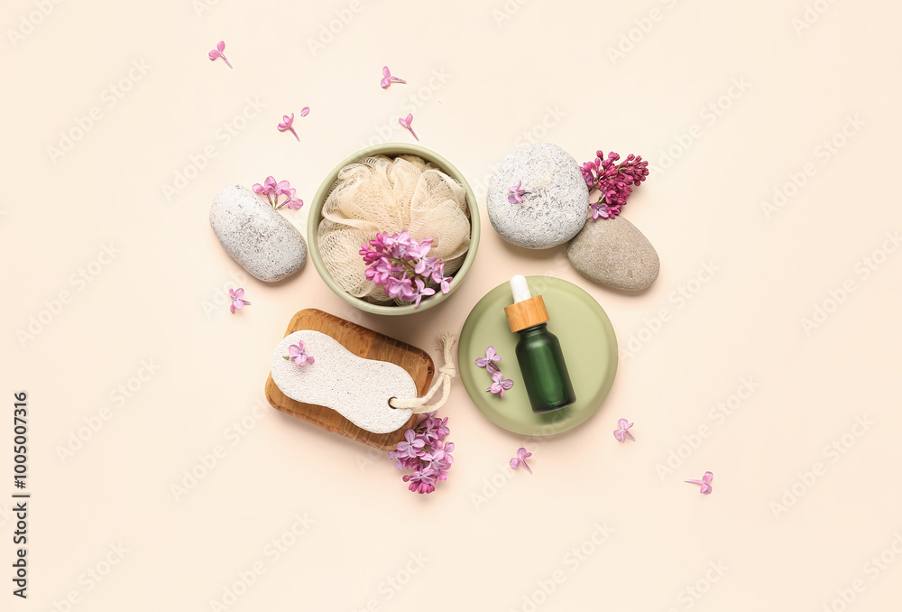 Foot file with bottle of cosmetic oil, loofah and lilac flowers on beige background Foot file with bottle of cosmetic oil, loofah and lilac flowers on beige background