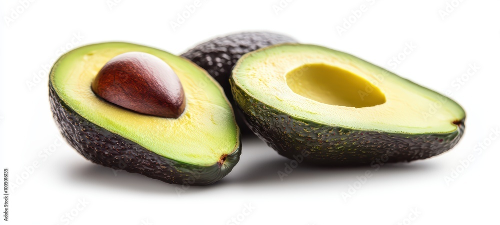 Halved avocados showcasing their creamy green flesh and dark pits, placed on a white background Halved avocados showcasing their creamy green flesh and dark pits, placed on a white background