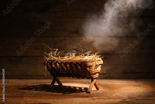 Canvas Print Manger with hay and smoke on dark wooden background