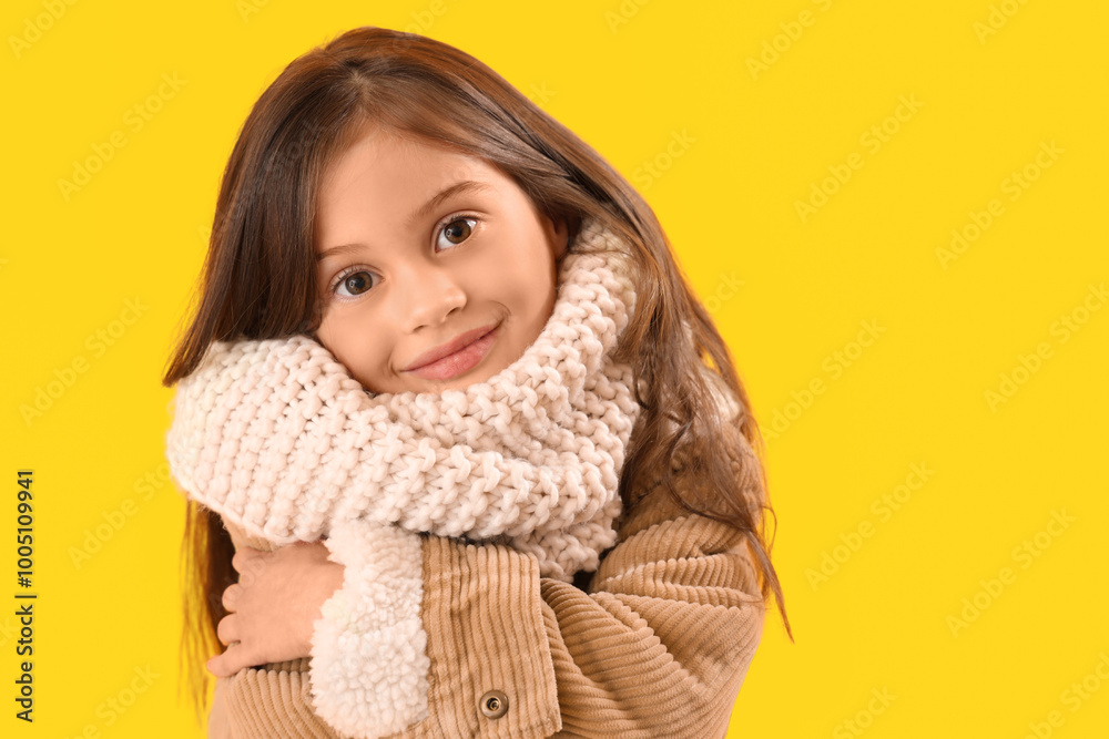 Little girl in winter clothes on yellow background, closeup Little girl in winter clothes on yellow background, closeup