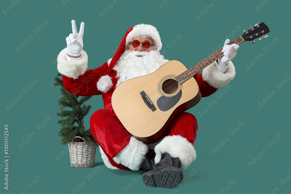 Cool Santa Claus with Christmas tree and guitar showing victory gesture on green background Cool Santa Claus with Christmas tree and guitar showing victory gesture on green background