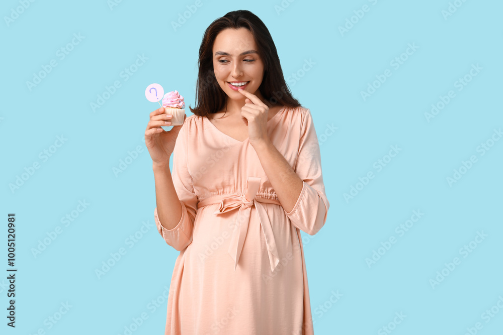 Beautiful happy pregnant woman with delicious cupcake and question mark on blue background. Gender reveal party concept Beautiful happy pregnant woman with delicious cupcake and question mark on blue background. Gender reveal party concept