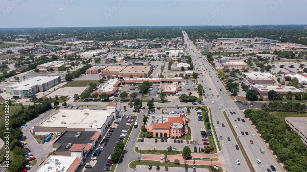 Overland Park, Kansas, USA - June 17, 2023: Morning traffic passes through the downtown commercial district of Overland Park.