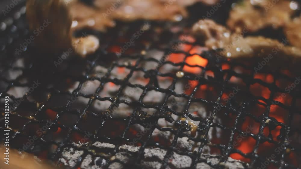 Grilled meat on a charcoal grill pan at Korean BBQ restaurant. Grilled meat on a charcoal grill pan at Korean BBQ restaurant.