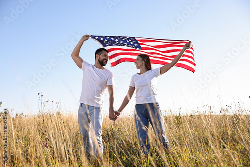 Happy couple with flag of USA outdoors