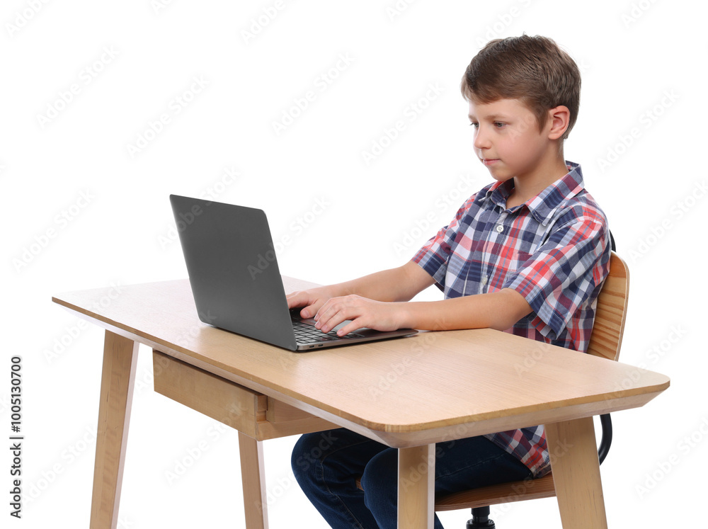 Boy with correct posture using laptop at wooden desk on white background Boy with correct posture using laptop at wooden desk on white background