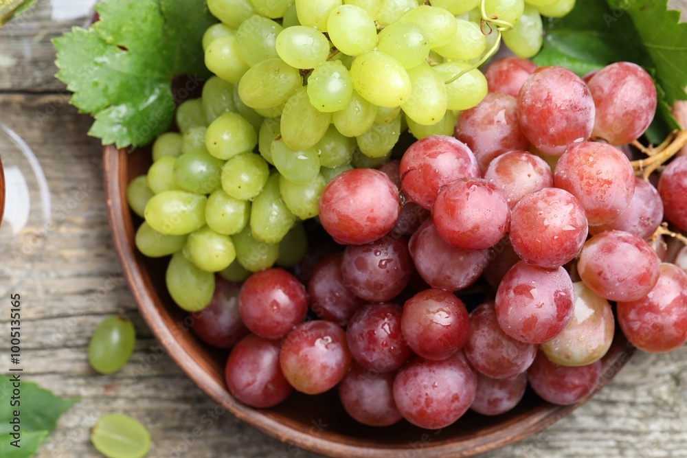Fresh ripe grapes on wooden table, top view