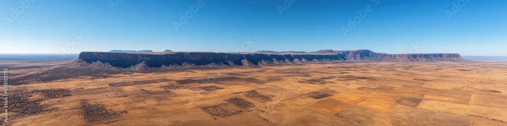 Naklejka premium Captivating Panoramic View of Monument Valley's Majestic Mesas and Vast Desert Landscape Under a Clear Blue Sky