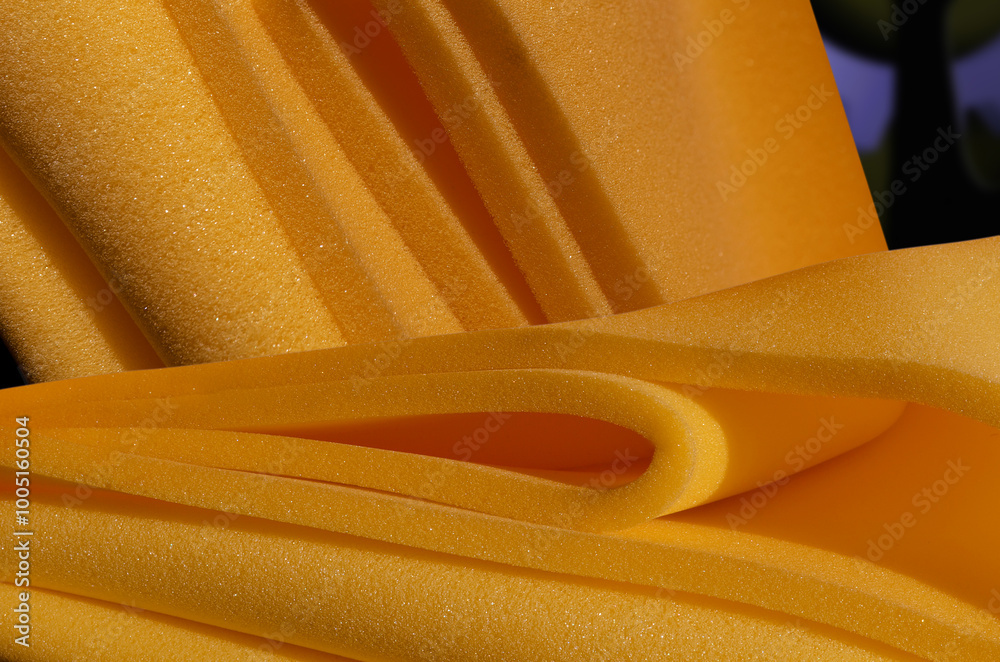 Φωτογραφία a collection and pile of dark yellow sponge foam material in a room