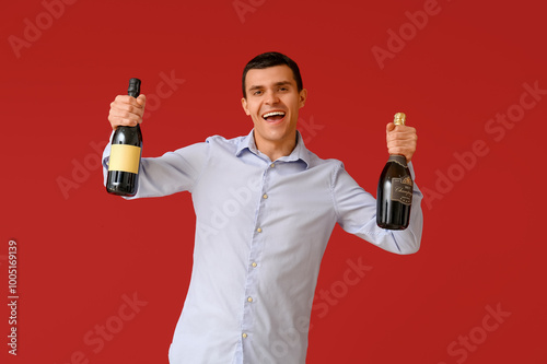 Happy young man with bottle...