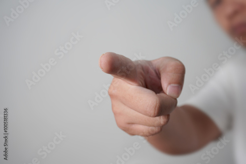 Tableau sur toile Anonymous man pointing forward, focus on finger with blurred face