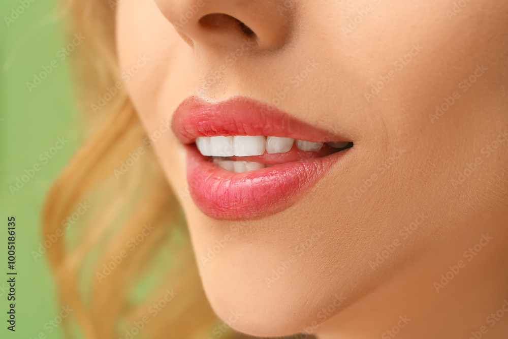 Fototapeta premium Young woman with beautiful lipstick on green background, closeup