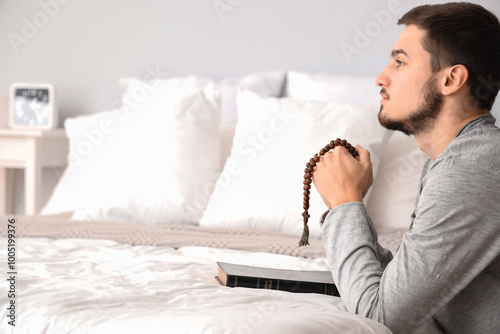 Young man with rosary beads...