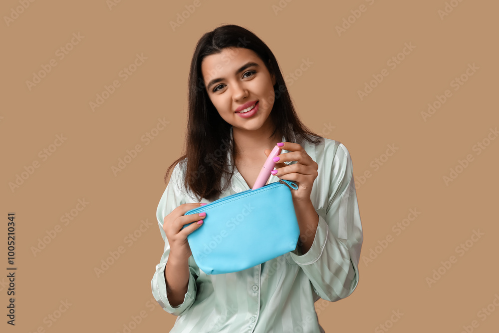 Beautiful young woman with cosmetic bag and mascara on color background Beautiful young woman with cosmetic bag and mascara on color background