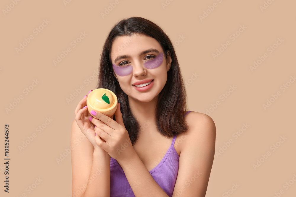 Beautiful young woman with under-eye patches holding jar of cosmetic product on color background Beautiful young woman with under-eye patches holding jar of cosmetic product on color background