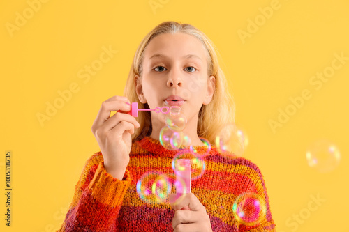 Happy teenager girl blowing...