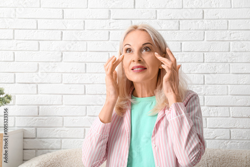 Mature woman touching wrink...