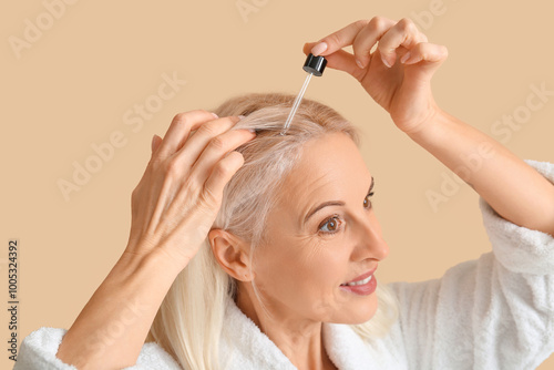 Mature woman applying cosme...