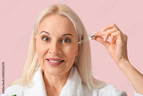 Mature woman applying essen...